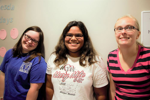 Three young women with developmental disabilities posing for a picture