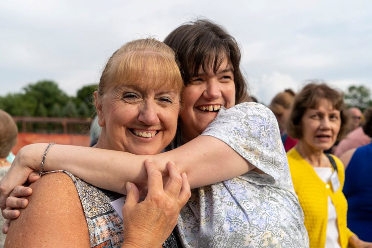 A woman with a developmental disability hugging her mother