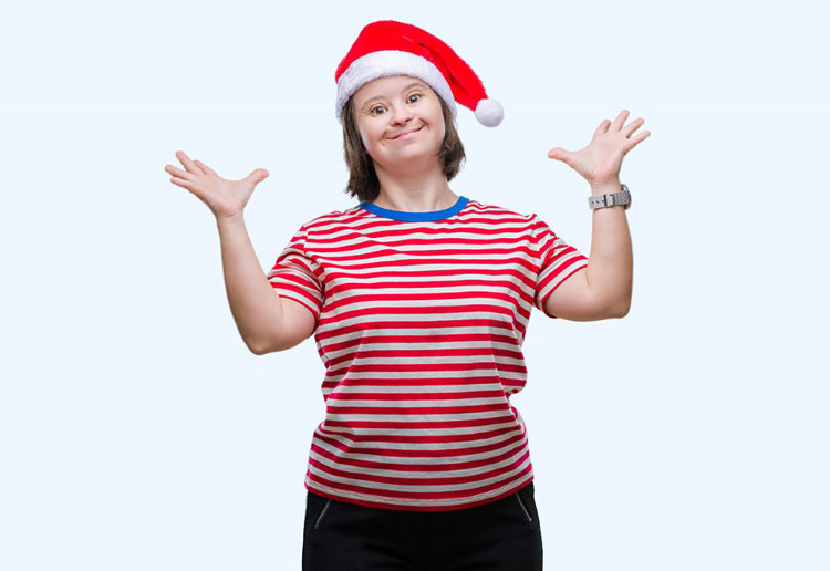 Woman with a developmental disability wearing a Santa hat and smiling