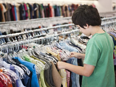 Child shopping for clothes in a thrift store
