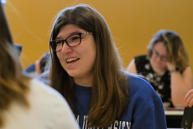 AbleLight College student smiling in the campus cafeteria