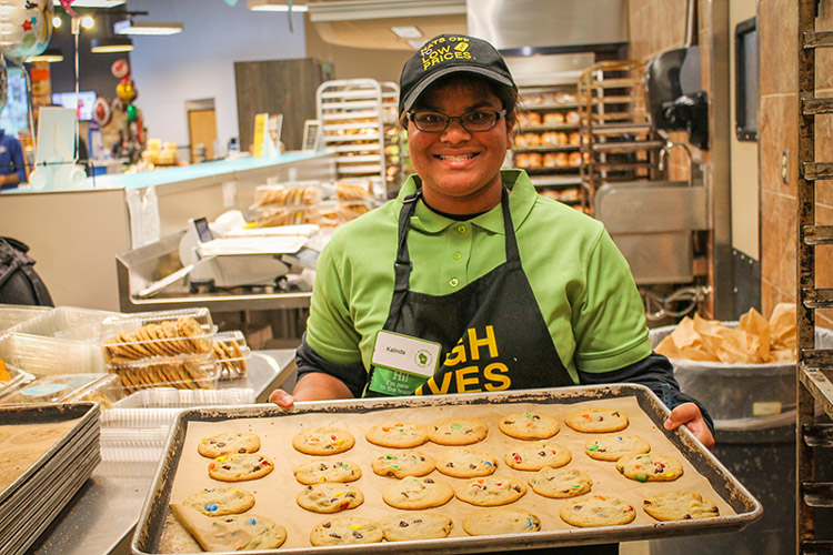 Kalindi works at a grocery store with support from AbleLight's job coaches