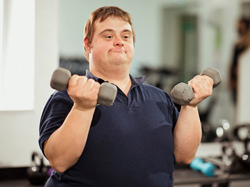 Man with a developmental disability lifting weights