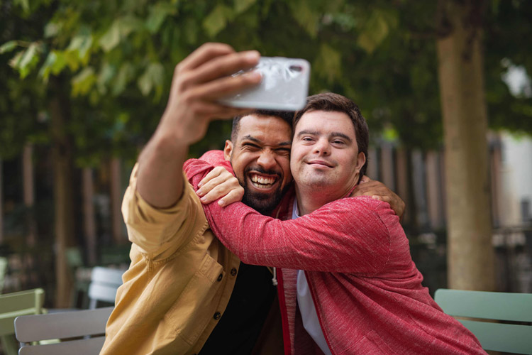 A father taking a selfie picture with his son who has a developmental disability