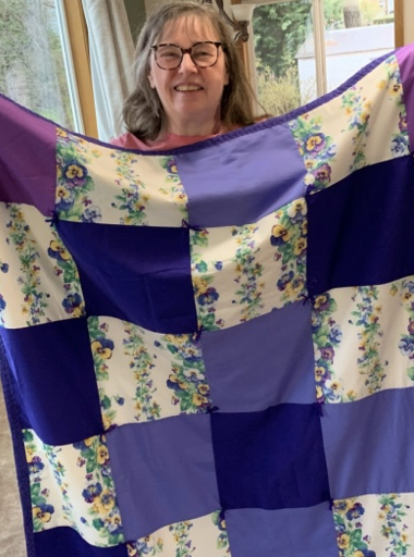 Mona Fuerstenau with gift quilt from Grace Lutheran Church, Longview