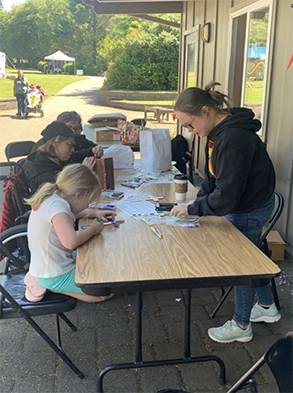 What fun for members of Redeemer LC in Tillamook as they helped people with disability build their own pre-drilled bird houses and decorate them! Olivia shared the Good News while some decorated a wooden cross with a Bible verse on the back. (Joni and Friends Disability Family Camp)