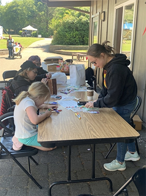 Group of people building birdhouses for a group home