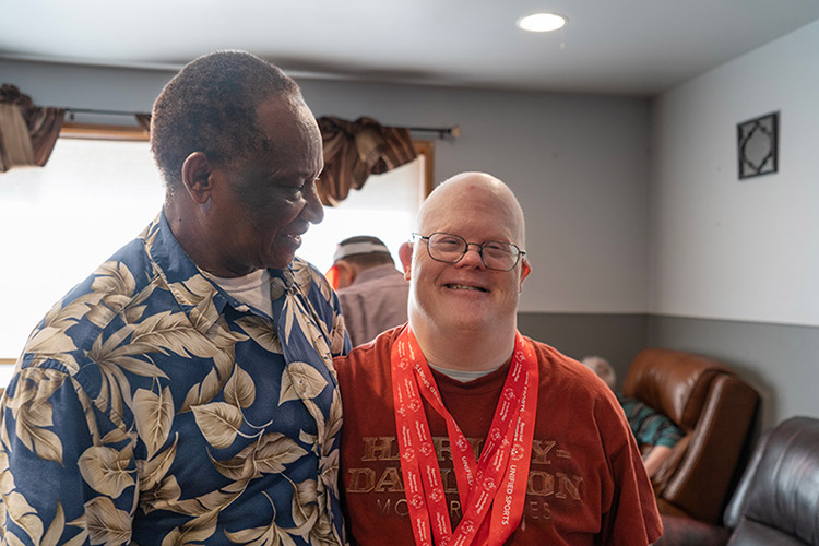 Man with IDD wearing Special Olympics medals