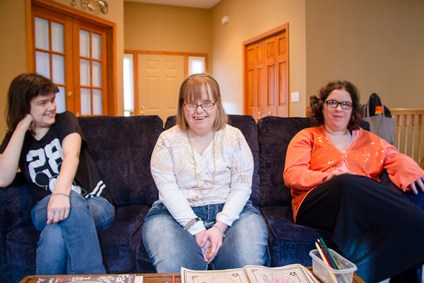 Group of three women with developmental disabilities sitting on a couch