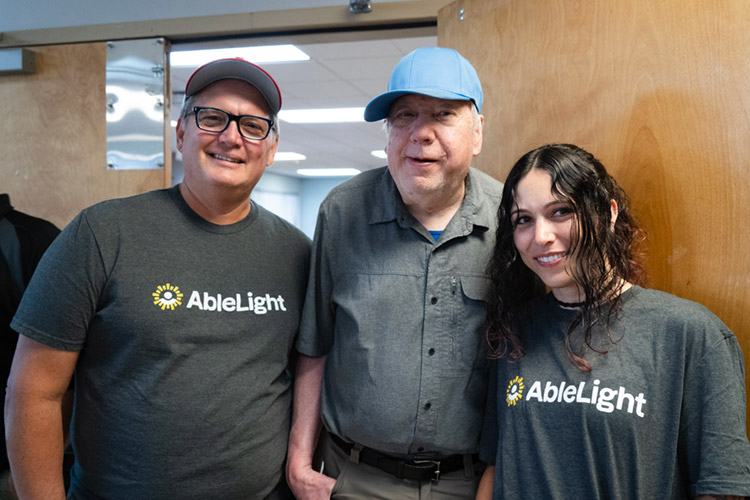 John and Brittany with John, a man supported by AbleLight