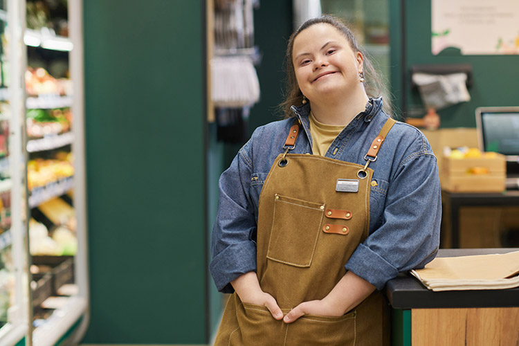 Girl with Down Syndrome Enjoying Work in Supermarket