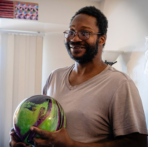 Ezechial smiling in his apartment