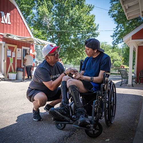 John and Davin, a man supported by AbleLight, in the park