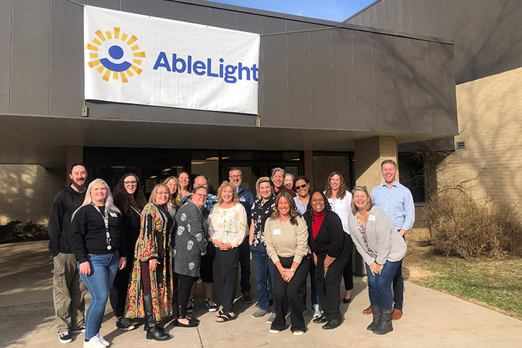 Group of AbleLight team members outside of a Colorado Day Program