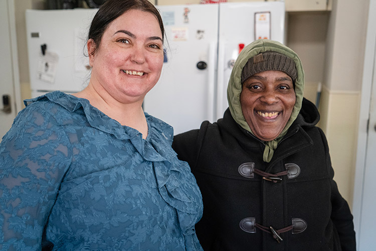 Shalanda and an AbleLight DSP smiling in the kitchen