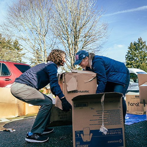 AbleLight Volunteers moving boxes