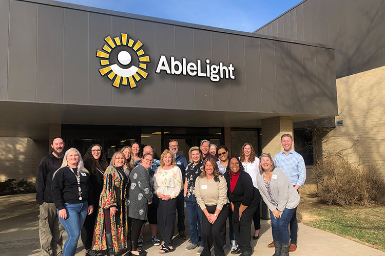 Group of AbleLight team members outside of an AbleLight building