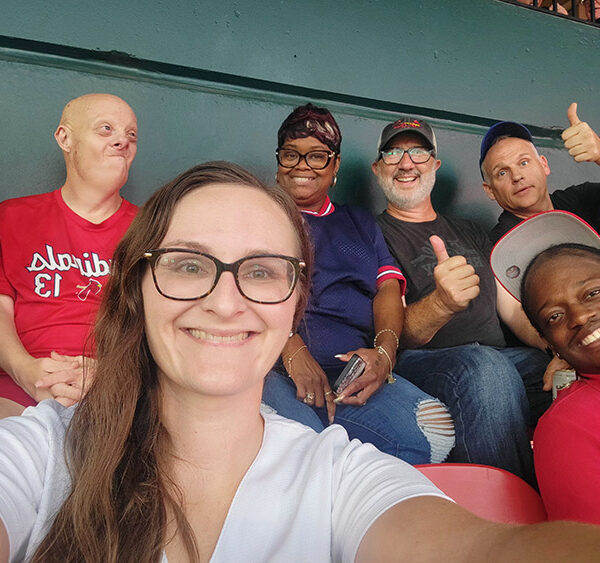 Keith Jones with AbleLight team members and people supported at a baseball game