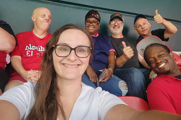 Keith Jones with AbleLight team members and people supported at a baseball game