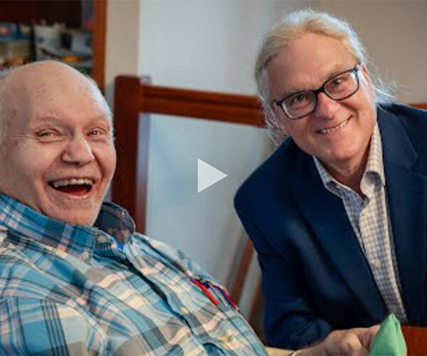 Jim, President of AbleLight's Board of Directors with a man supported by AbleLight's services