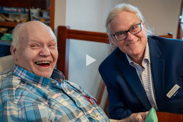 Jim, President of AbleLight's Board of Directors with a man supported by AbleLight's services