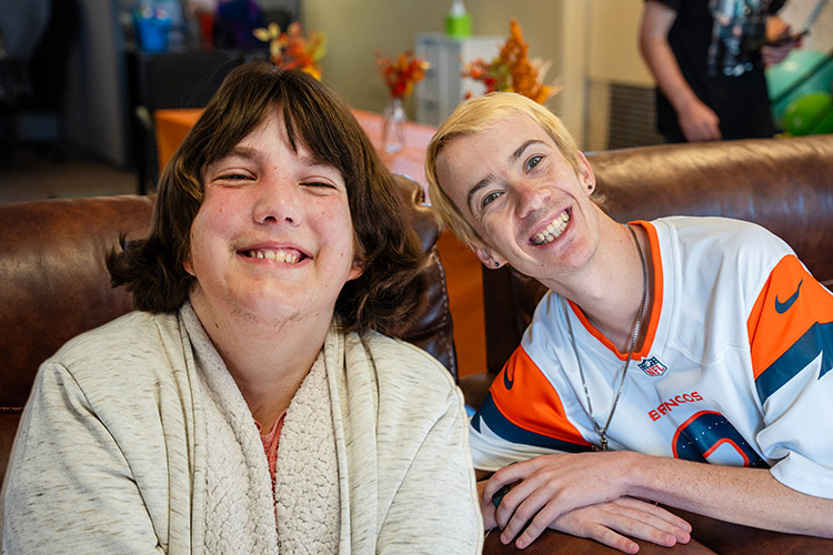 Two smiling participants in AbleLight's Day Program in Colorado Springs