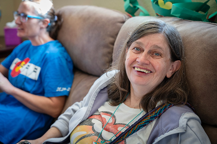 A woman with a developmental disability smiling at an AbleLight Day Program.