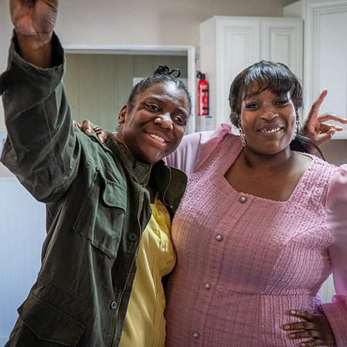 Jasmine and her Shared Living Provider, Catherine, smiling in a kitchen