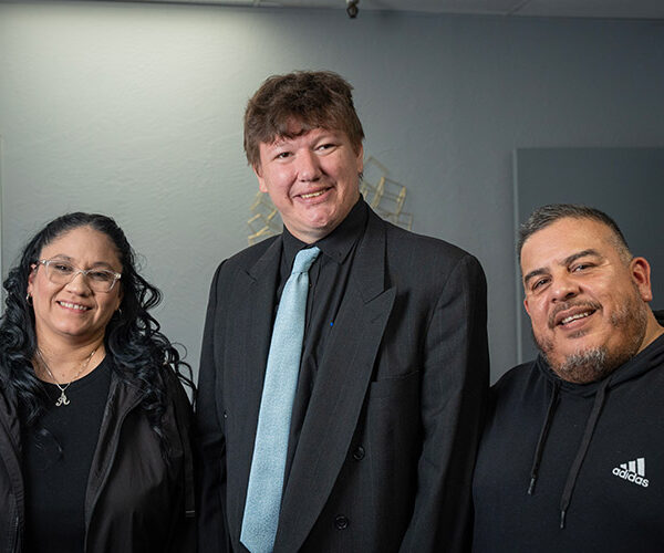 A well-dressed man with a developmental disability and two staff members from AbleLight's employment services