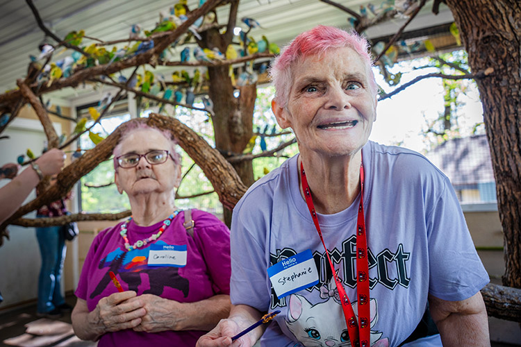 Two women with developmental disabilities smiling