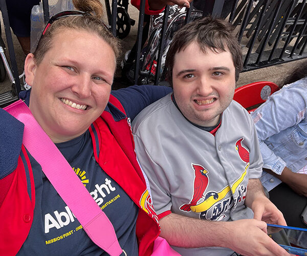AbleLight team member and person supported at a baseball game