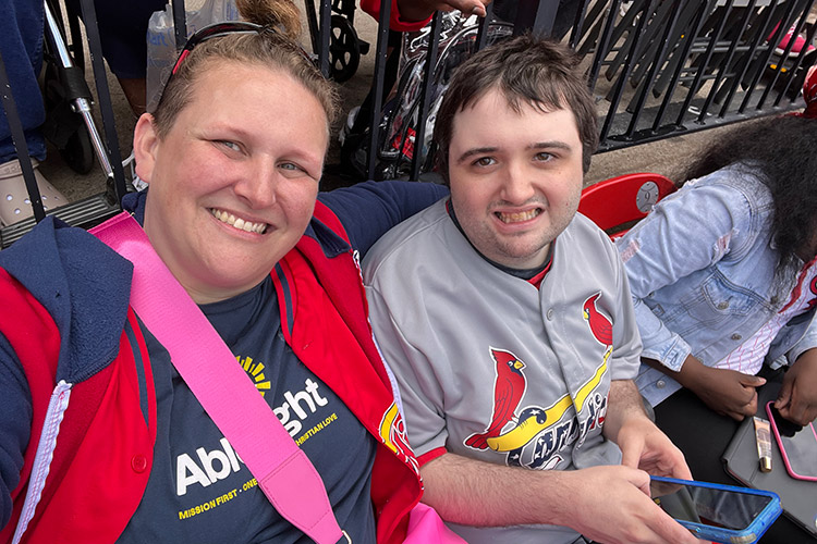 AbleLight team member and person supported at a baseball game