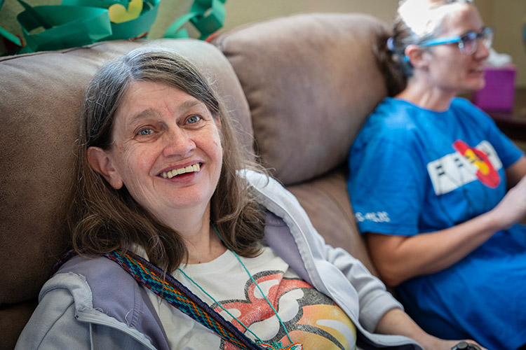 A smiling woman at AbleLight's Day Program in Colorado Springs