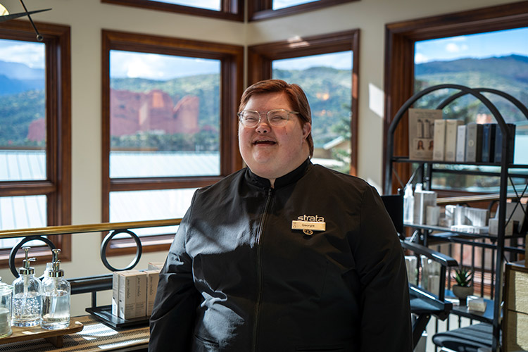 A woman with a developmental disability at work smiling