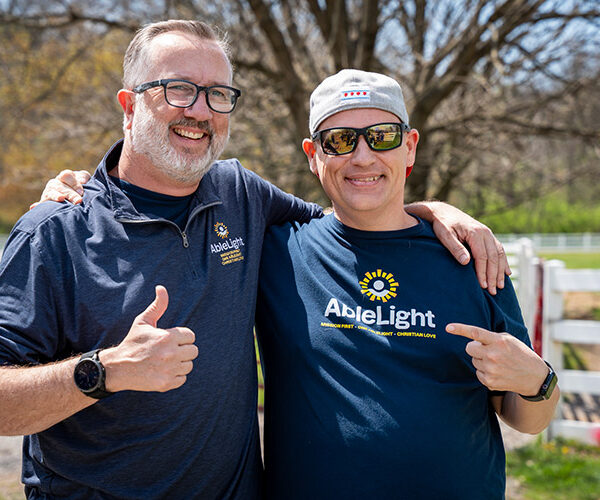 Keith Jones, AbleLight CEO with a man supported by AbleLight