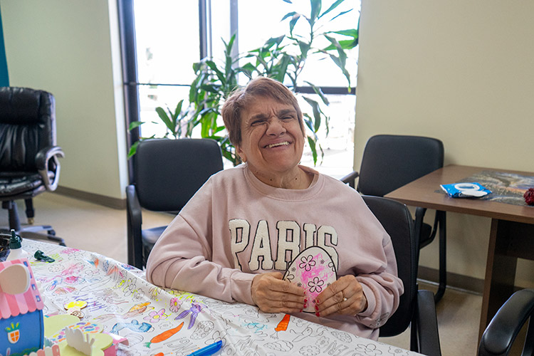 A smiling participant from AbleLight's Day Program