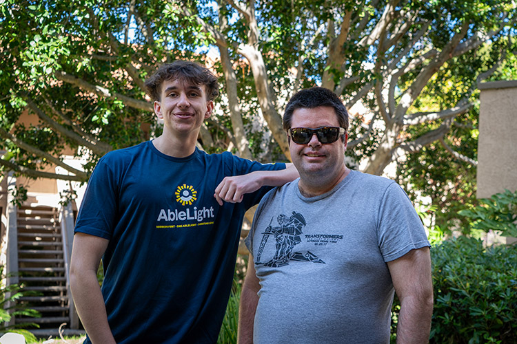 An AbleLight DSP with a man supported by AbleLight's services