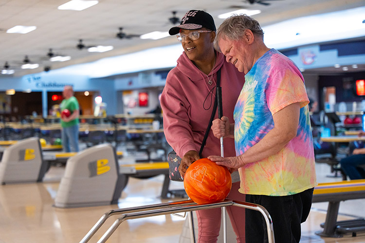 An AbleLight DSP and a man with a disability bowling