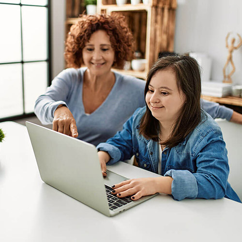A woman with a developmental disability on a laptop computer