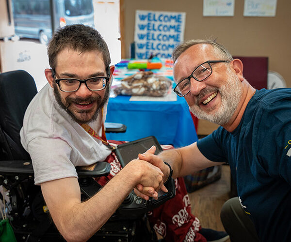 A man supported by AbleLight with Keith Jones, President and CEO of AbleLight