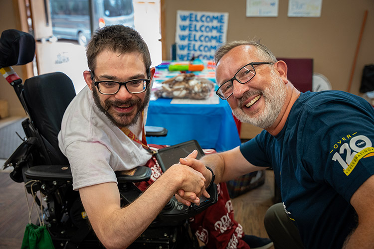 A man supported by AbleLight with Keith Jones, President and CEO of AbleLight