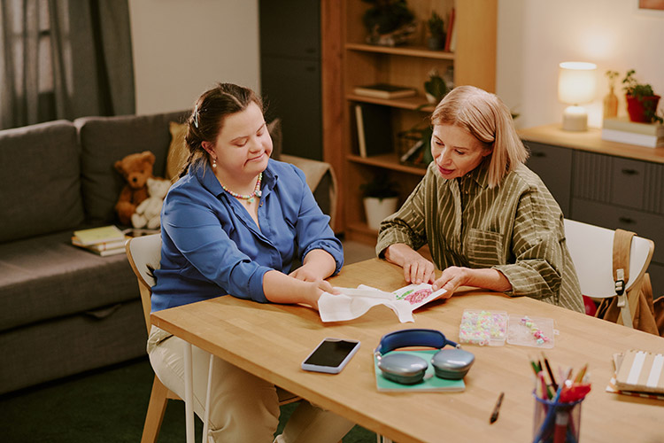 A mother and daughter reviewing paperwork together