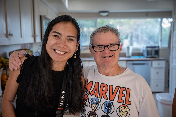 An older man supported by AbleLight with an AbleLight team member